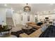Open-concept layout connecting the living room to the kitchen, featuring hardwood floors and modern decor at 6950 Hidden Cove Ct, Castle Pines, CO 80108