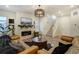Living room featuring a fireplace, hardwood floors, and modern decor at 6950 Hidden Cove Ct, Castle Pines, CO 80108