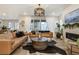 Bright living room featuring hardwood floors, modern furnishings, and a decorative fireplace at 6950 Hidden Cove Ct, Castle Pines, CO 80108