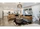 Open-concept living room with hardwood floors, stylish sofas, and natural light at 6950 Hidden Cove Ct, Castle Pines, CO 80108