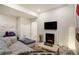 Stylish living room offers an electric fireplace, TV, and a playful flamingo print to catch your eye at 6950 Hidden Cove Ct, Castle Pines, CO 80108
