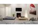 Chic living room featuring an electric fireplace, TV, and an artistic flamingo print at 6950 Hidden Cove Ct, Castle Pines, CO 80108