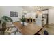 Open concept living space featuring a kitchen island, dining area, and comfortable seating at 6950 Hidden Cove Ct, Castle Pines, CO 80108