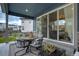 Inviting covered patio with a cozy seating area and sliding glass doors at 6950 Hidden Cove Ct, Castle Pines, CO 80108
