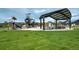 Community playground with a covered picnic area and green space at 6950 Hidden Cove Ct, Castle Pines, CO 80108
