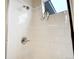 Shower with white tiled walls, rainfall shower head, and corner ledge at 6950 Hidden Cove Ct, Castle Pines, CO 80108