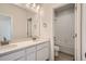 Bathroom featuring double sinks with large mirror and tiled shower/tub combo in the background at 1300 Loraine N Cir, Lafayette, CO 80026