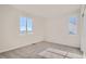 Bedroom with light colored carpet, two windows letting in light, and neutral paint at 1300 Loraine N Cir, Lafayette, CO 80026