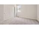 Bedroom with a large window letting in light with closet and neutral walls and carpeted floor at 1300 Loraine N Cir, Lafayette, CO 80026