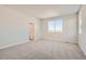 Spacious primary bedroom with large windows, plush carpet, and neutral wall color at 1300 Loraine N Cir, Lafayette, CO 80026