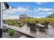 Outdoor patio seating area with a fire pit, landscaping, and a tranquil water feature at 1677 Meagan Way, Erie, CO 80516