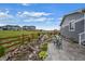 Landscaped backyard with a charming seating area next to a peaceful rock water feature at 1677 Meagan Way, Erie, CO 80516