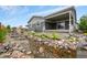 Backyard patio with water feature, landscaping, and covered patio perfect for outdoor relaxing at 1677 Meagan Way, Erie, CO 80516