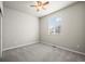 A room with neutral-toned walls, carpet flooring, a ceiling fan, and a window with blinds to let in natural light at 1677 Meagan Way, Erie, CO 80516