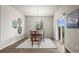 Charming dining room features a wood table, stylish decor, and bright natural light from a sliding glass door at 1677 Meagan Way, Erie, CO 80516