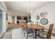 Lovely dining room with an open floorplan, traditional furniture, and an ornate chandelier offers comfortable entertaining at 1677 Meagan Way, Erie, CO 80516