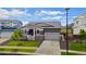 Charming home featuring stone accents, a two-car garage, and a well-maintained front yard at 1677 Meagan Way, Erie, CO 80516