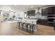 Bright and spacious kitchen with an island, stainless appliances, and open-concept layout at 1677 Meagan Way, Erie, CO 80516