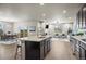 Open floor plan with kitchen island flowing into the dining and living areas at 1677 Meagan Way, Erie, CO 80516