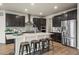 Bright kitchen with an island, stainless steel appliances, and dark wood cabinets at 1677 Meagan Way, Erie, CO 80516