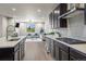 Open-concept kitchen with island, seating, and view into the adjacent living area at 1677 Meagan Way, Erie, CO 80516
