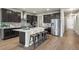 Stunning kitchen with large island, stainless steel appliances, and abundant dark wood cabinetry at 1677 Meagan Way, Erie, CO 80516