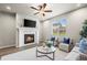Inviting living room with a modern fireplace, contemporary furniture, and a ceiling fan offers comfort and style at 1677 Meagan Way, Erie, CO 80516