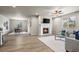 Spacious living room offers a fireplace, plush seating, and wood floors that flow into a well-appointed dining area at 1677 Meagan Way, Erie, CO 80516