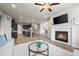 Spacious open-concept living area showcasing a fireplace, wood floors, and adjacent kitchen and dining spaces at 1677 Meagan Way, Erie, CO 80516