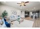 Open-concept living room features a stylish sofa, open-concept kitchen, and inviting atmosphere at 1677 Meagan Way, Erie, CO 80516