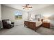 Serene primary bedroom features cozy carpet, ample natural light, and calming decor for a relaxing retreat at 1677 Meagan Way, Erie, CO 80516