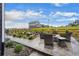 A backyard patio features wicker chairs around a fire pit and beautiful rock garden landscaping at 1677 Meagan Way, Erie, CO 80516