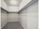 Empty walk-in closet with carpet flooring and shelves for storage and organization at 1677 Meagan Way, Erie, CO 80516
