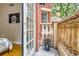 Balcony next to an open door showing the bedroom and overlooking the building at 1950 N Logan St # 108, Denver, CO 80203