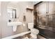 Charming bathroom with stylish floors, toilet, sink and dark wood cabinets at 1950 N Logan St # 108, Denver, CO 80203