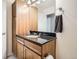 Bathroom featuring wooden vanity with granite countertop and a large mirror at 1950 N Logan St # 108, Denver, CO 80203