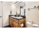 Bathroom featuring double sinks, wooden vanity with black countertop and a large mirror at 1950 N Logan St # 108, Denver, CO 80203