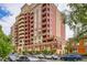 Stately brick apartment building with multiple balconies, reflecting a blend of luxury and urban living at 1950 N Logan St # 108, Denver, CO 80203