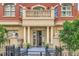 Elegant brick building facade with a private balcony and column-lined entrance at 1950 N Logan St # 108, Denver, CO 80203