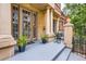 Inviting front porch with stone columns and potted plants, creating a warm and welcoming entrance at 1950 N Logan St # 108, Denver, CO 80203