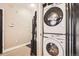 Laundry Room features stacked washer and dryer and storage shelves at 1950 N Logan St # 108, Denver, CO 80203