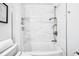 Modern bathroom features a shower and tub with marble-style tiled walls at 525 Jackson St # 303, Denver, CO 80206