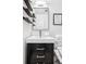 Well-lit bathroom with a stylish vanity, modern fixtures, and decorative floating shelves at 525 Jackson St # 303, Denver, CO 80206