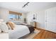 Bright bedroom with hardwood floors, natural light, and a cozy contemporary style at 525 Jackson St # 303, Denver, CO 80206