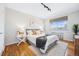 Comfortable bedroom with a soft rug, cozy bedding, and a sunlit window view at 525 Jackson St # 303, Denver, CO 80206