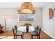 Cozy dining area with a round table, modern chairs, and a statement lighting fixture at 525 Jackson St # 303, Denver, CO 80206