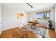 Bright home office with natural light, a stylish desk, and hardwood floors at 525 Jackson St # 303, Denver, CO 80206