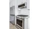 Modern kitchen with stainless steel appliances, white cabinetry, and granite countertops at 525 Jackson St # 303, Denver, CO 80206