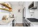 Modern kitchen with stainless steel appliances, white cabinets, and granite countertops at 525 Jackson St # 303, Denver, CO 80206