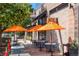 Outdoor seating at SOL Cocina restaurant with bright orange umbrellas at 525 Jackson St # 303, Denver, CO 80206